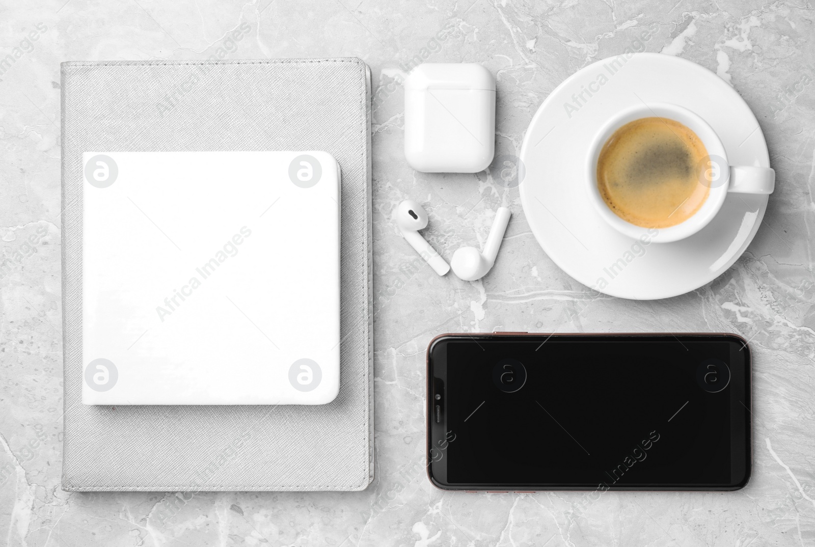 Photo of Flat lay composition with smartphone and cup of coffee on grey marble table