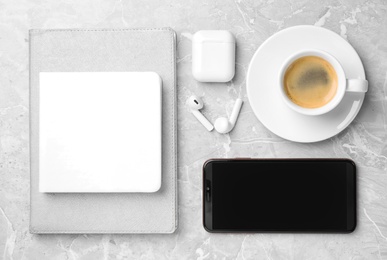 Flat lay composition with smartphone and cup of coffee on grey marble table