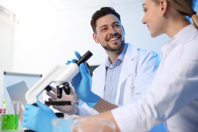 Scientists working at table in modern chemistry laboratory