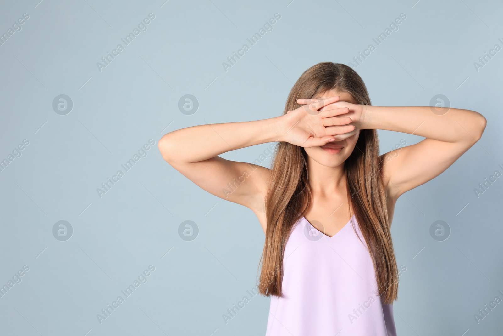 Photo of Young woman being blinded on grey background, space for text