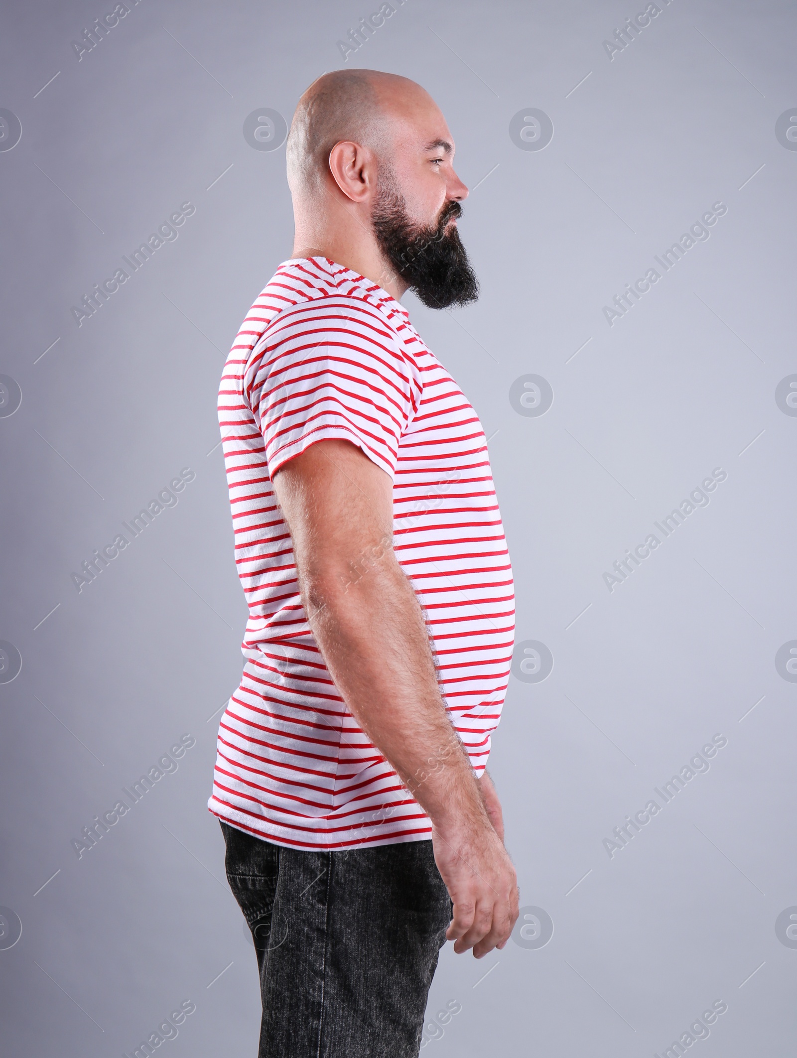 Photo of Fat man on grey background. Weight loss