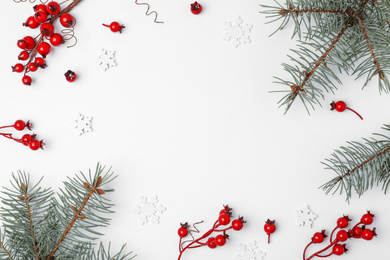 Photo of Winter composition with decorative branches and fir tree on white background, top view