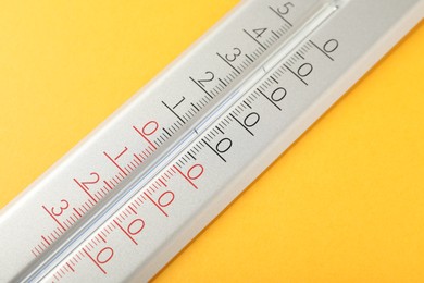 Photo of Modern weather thermometer on yellow background, closeup