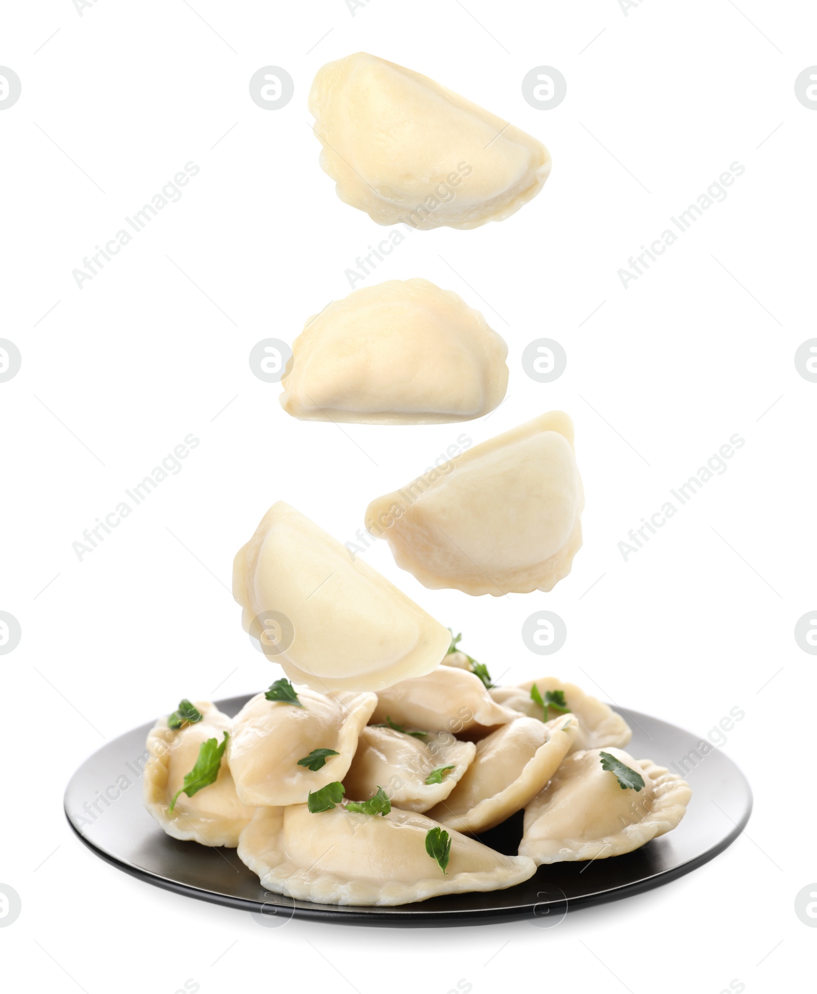 Image of Many tasty dumplings falling on white background