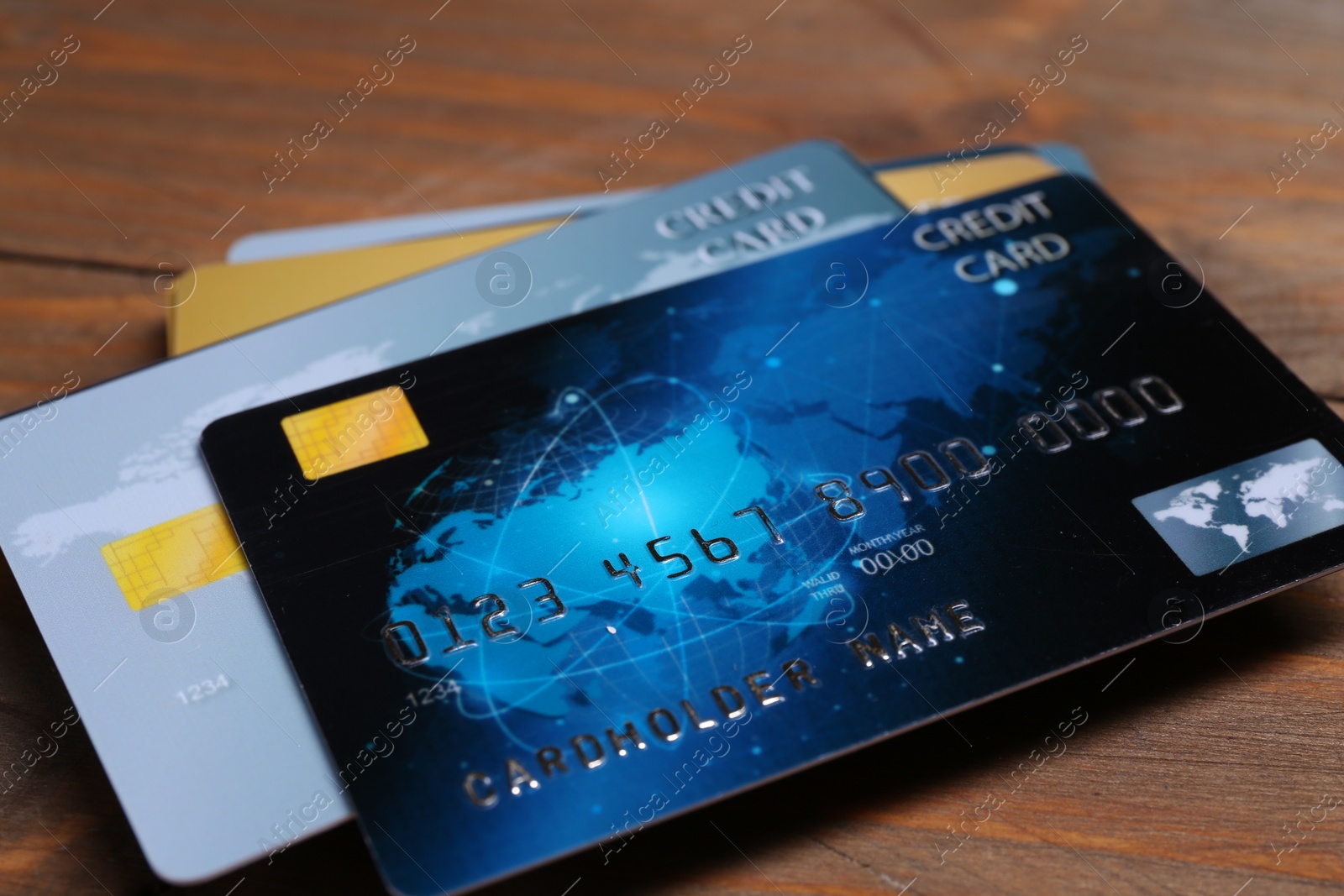Photo of Many credit cards on wooden table, closeup