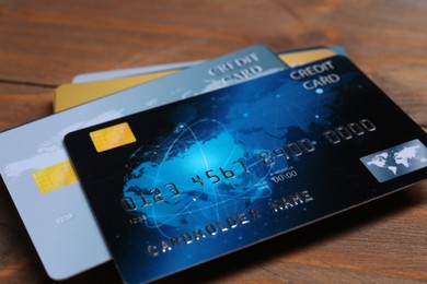 Photo of Many credit cards on wooden table, closeup