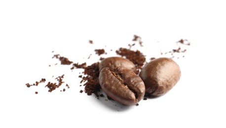 Coffee grounds and roasted beans on white background