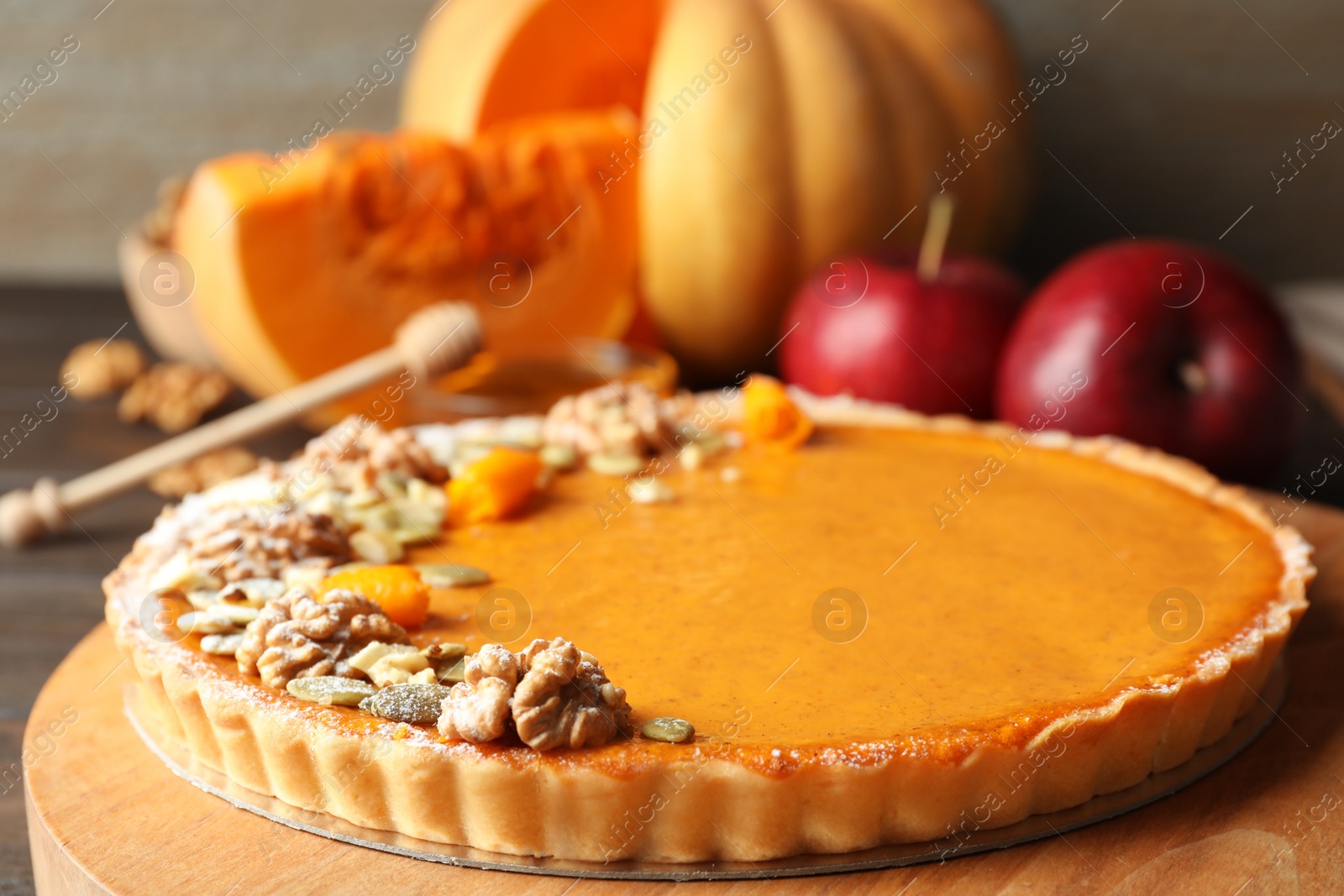 Photo of Delicious fresh homemade pumpkin pie on wooden table, closeup