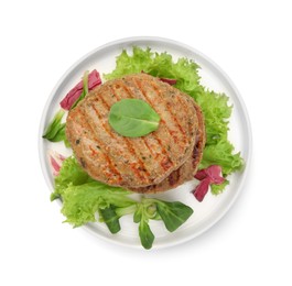 Photo of Plate of delicious vegan cutlets, lettuce and spinach isolated on white, top view