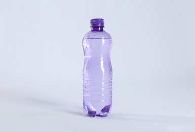 Plastic bottle of pure water on light background