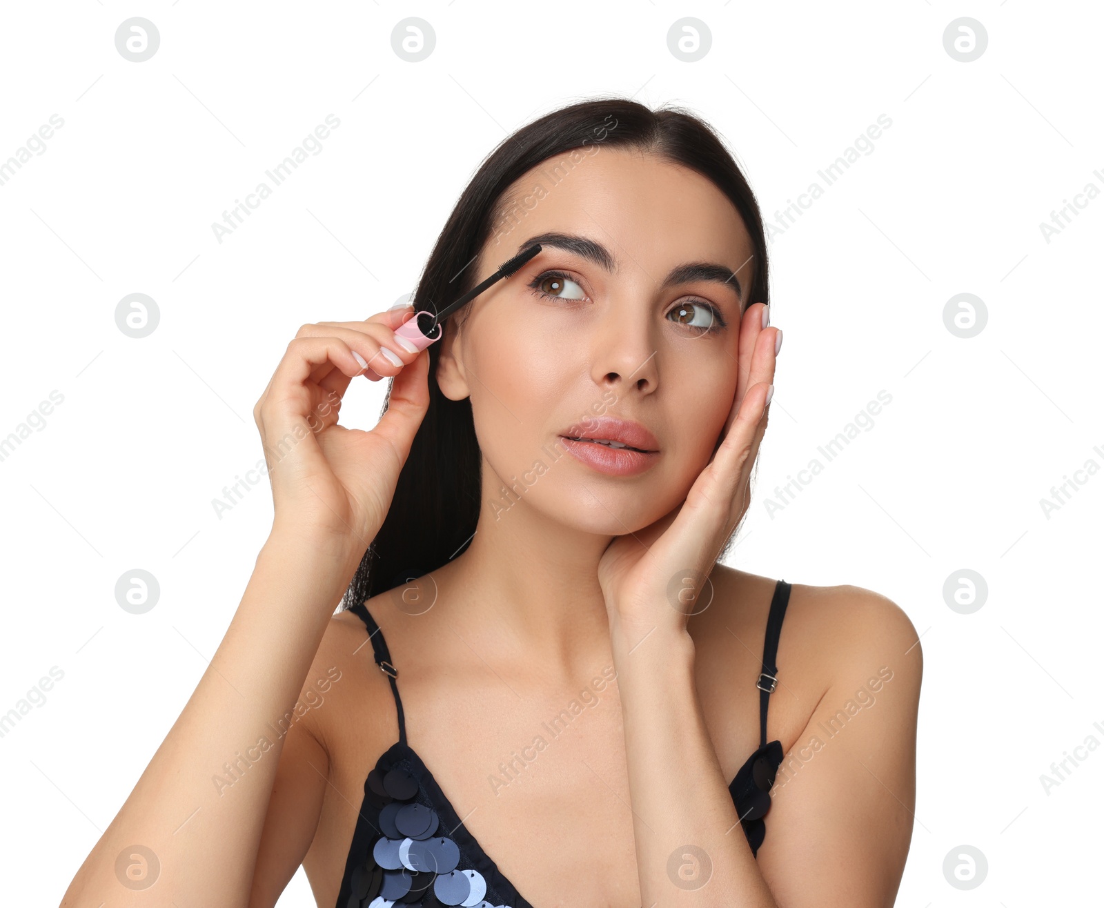 Photo of Beautiful young woman applying mascara on white background