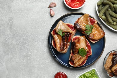 Photo of Tasty sandwiches with fried pork fatback slices on light grey table, flat lay. Space for text