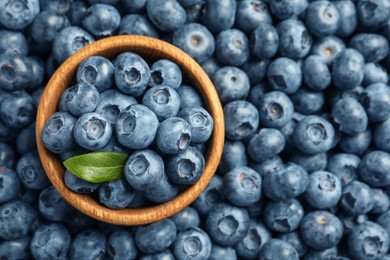 Photo of Tasty fresh blueberries and bowl, top view