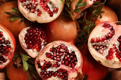 Photo of Delicious ripe pomegranates as background, top view