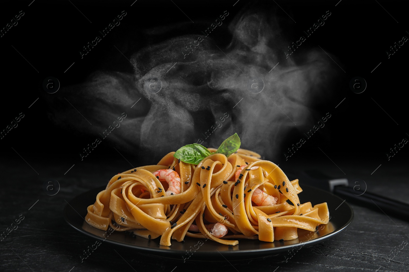 Image of Tasty buckwheat noodles with shrimps on black table