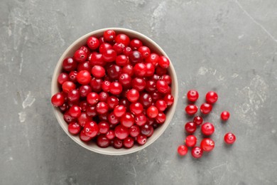 Photo of Cranberries in bowl on light grey table, top view