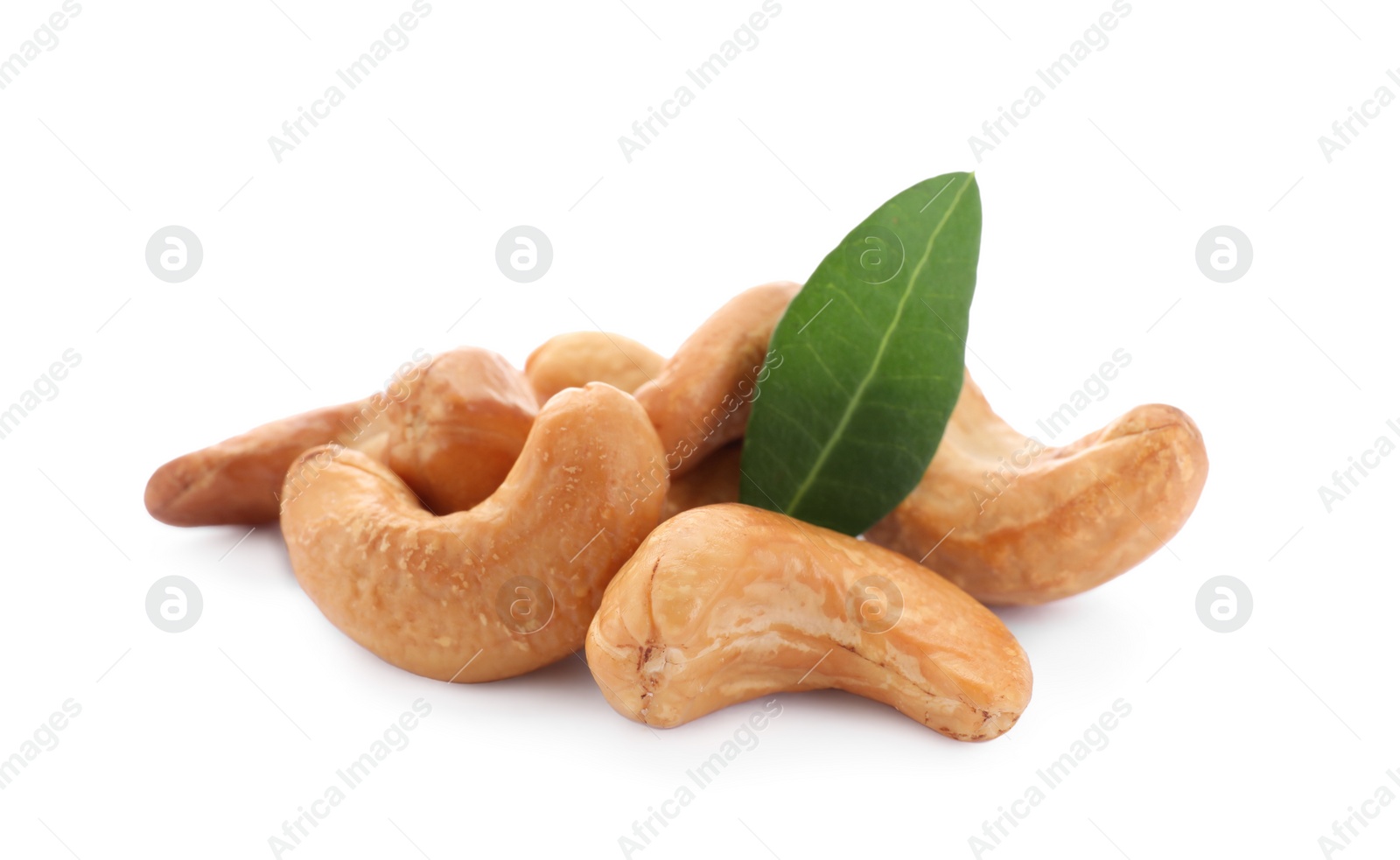 Photo of Pile of tasty organic cashew nuts and green leaf isolated on white