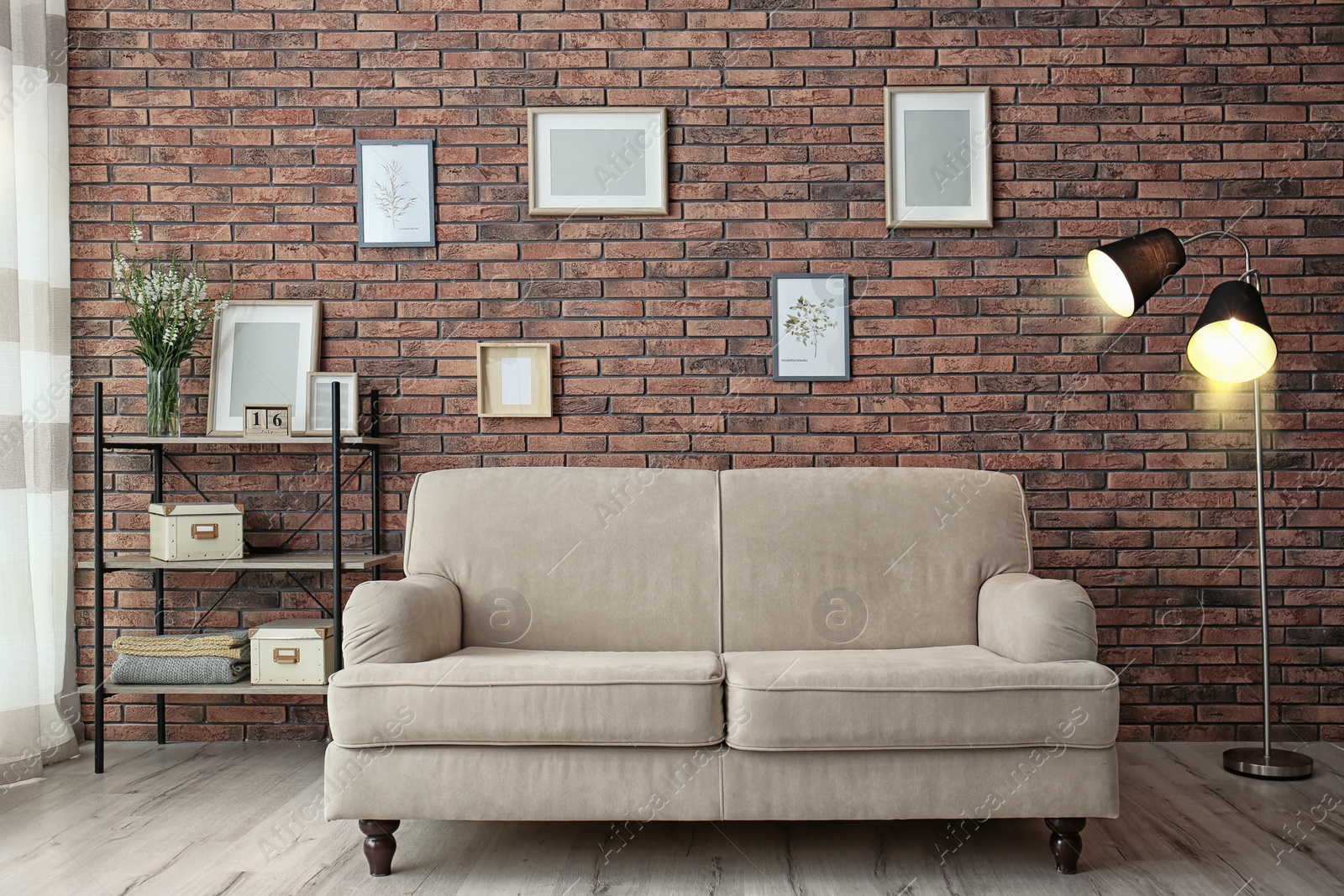 Photo of Modern living room interior with comfortable sofa near brick wall