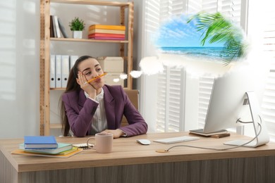 Young woman dreaming about vacation at table in office