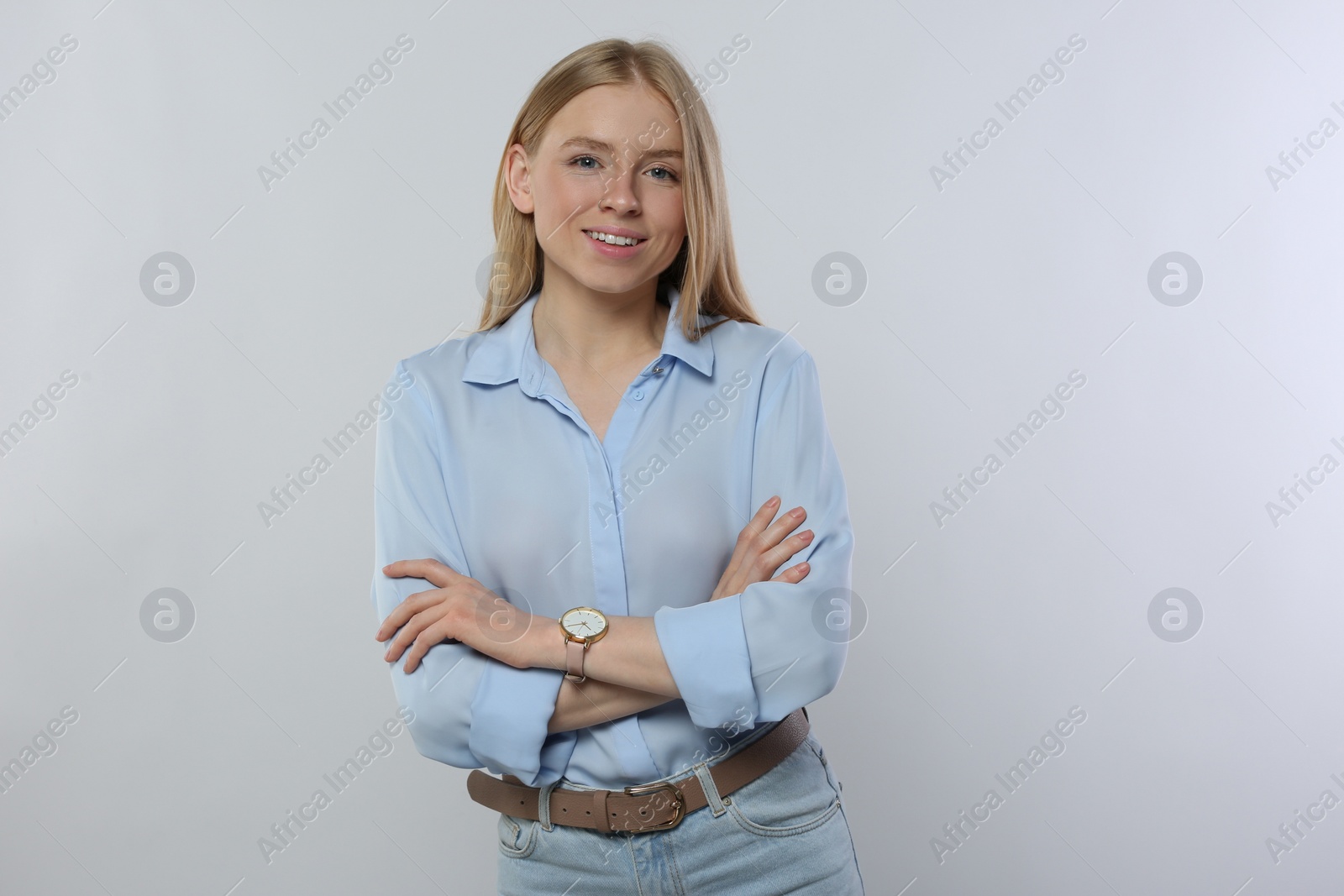 Photo of Portrait of beautiful young woman in stylish blouse on white background