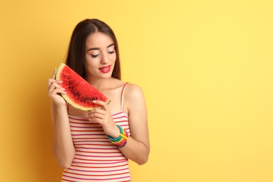 Photo of Beautiful young woman posing with watermelon on color background