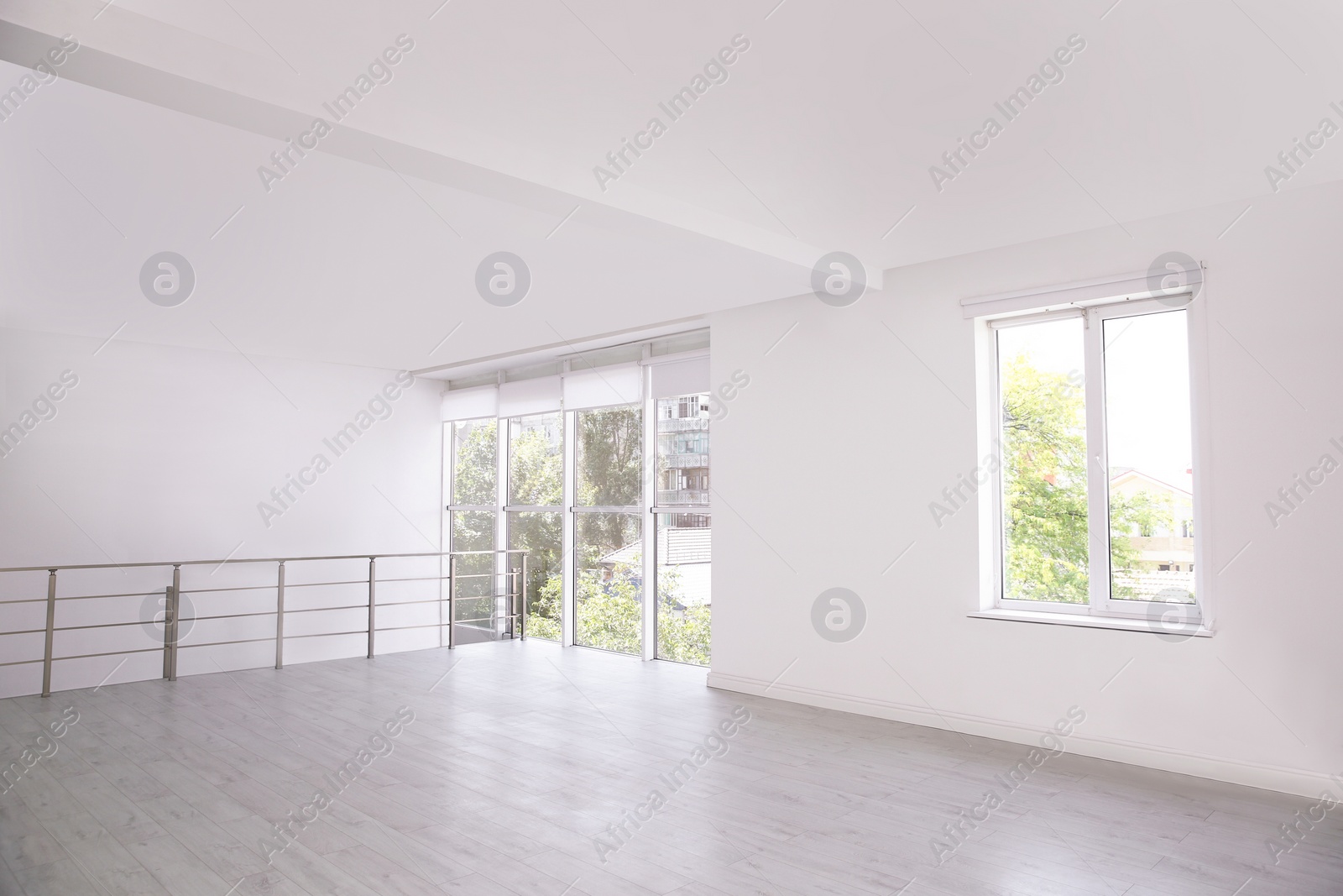 Photo of Empty room with windows and laminated floor