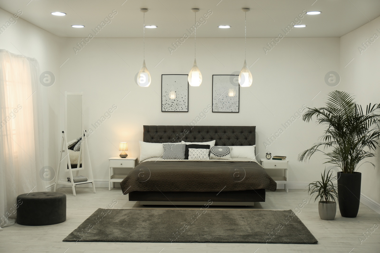 Photo of Stylish room interior with large comfortable bed