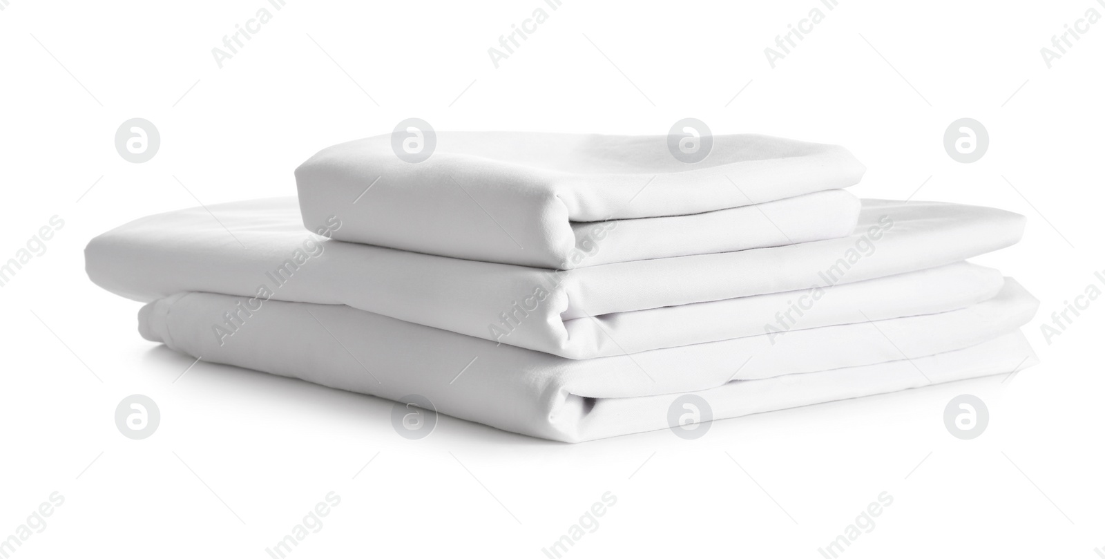 Photo of Stack of clean bed linen isolated on white