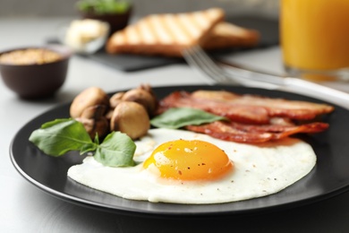Tasty breakfast with fried egg on table, closeup