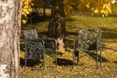 Photo of Pair of camping chairs in park on sunny day