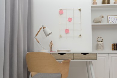 Photo of Desk lamp on table in stylish room