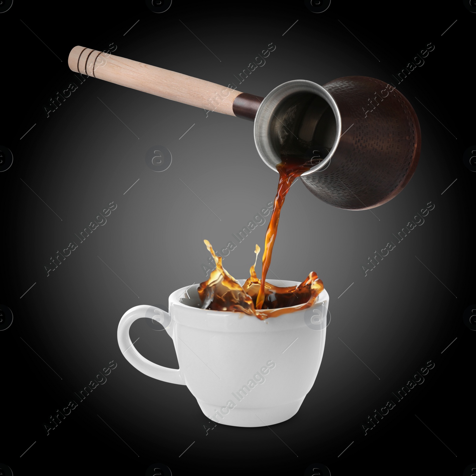 Image of Pouring freshly brewed aromatic coffee from turkish pot into cup. Objects in air on black background