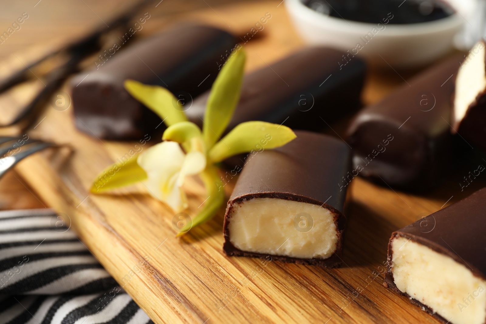 Photo of Glazed vanilla curd cheese bars on table, closeup