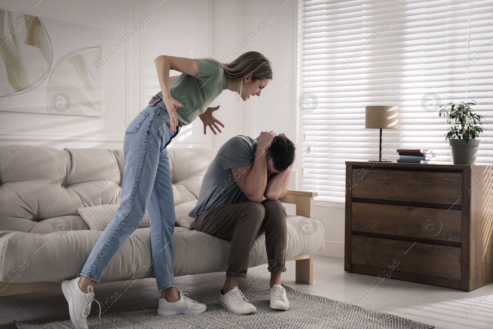 Photo of Woman abusing man at home. Domestic violence