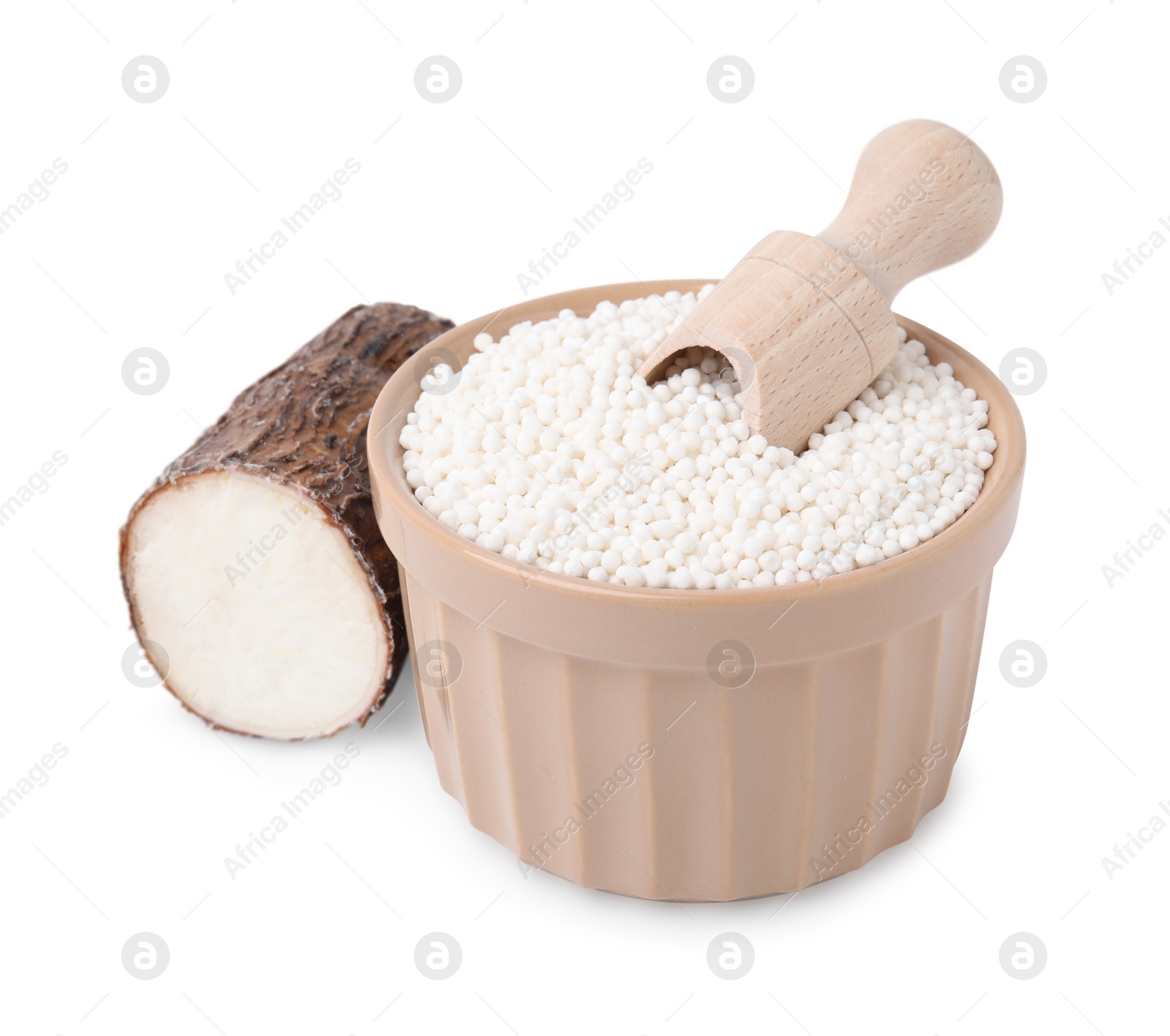 Photo of Tapioca pearls in bowl, scoop and cassava root isolated on white