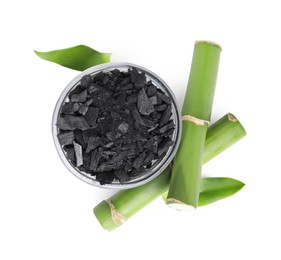 Photo of Fresh bamboo and charcoal on white background, top view