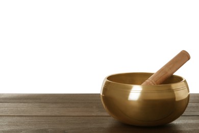 Photo of Golden singing bowl and mallet on wooden table against white background, space for text