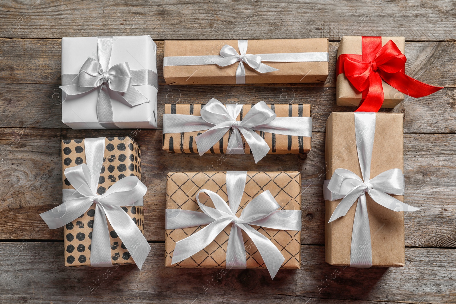 Photo of Beautiful gift boxes on wooden background, top view