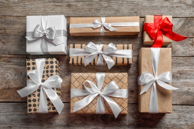 Photo of Beautiful gift boxes on wooden background, top view