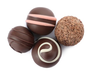 Photo of Many different delicious chocolate truffles on white background, top view