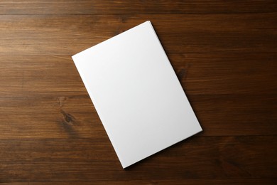 Blank paper brochure on wooden table, top view. Mockup for design