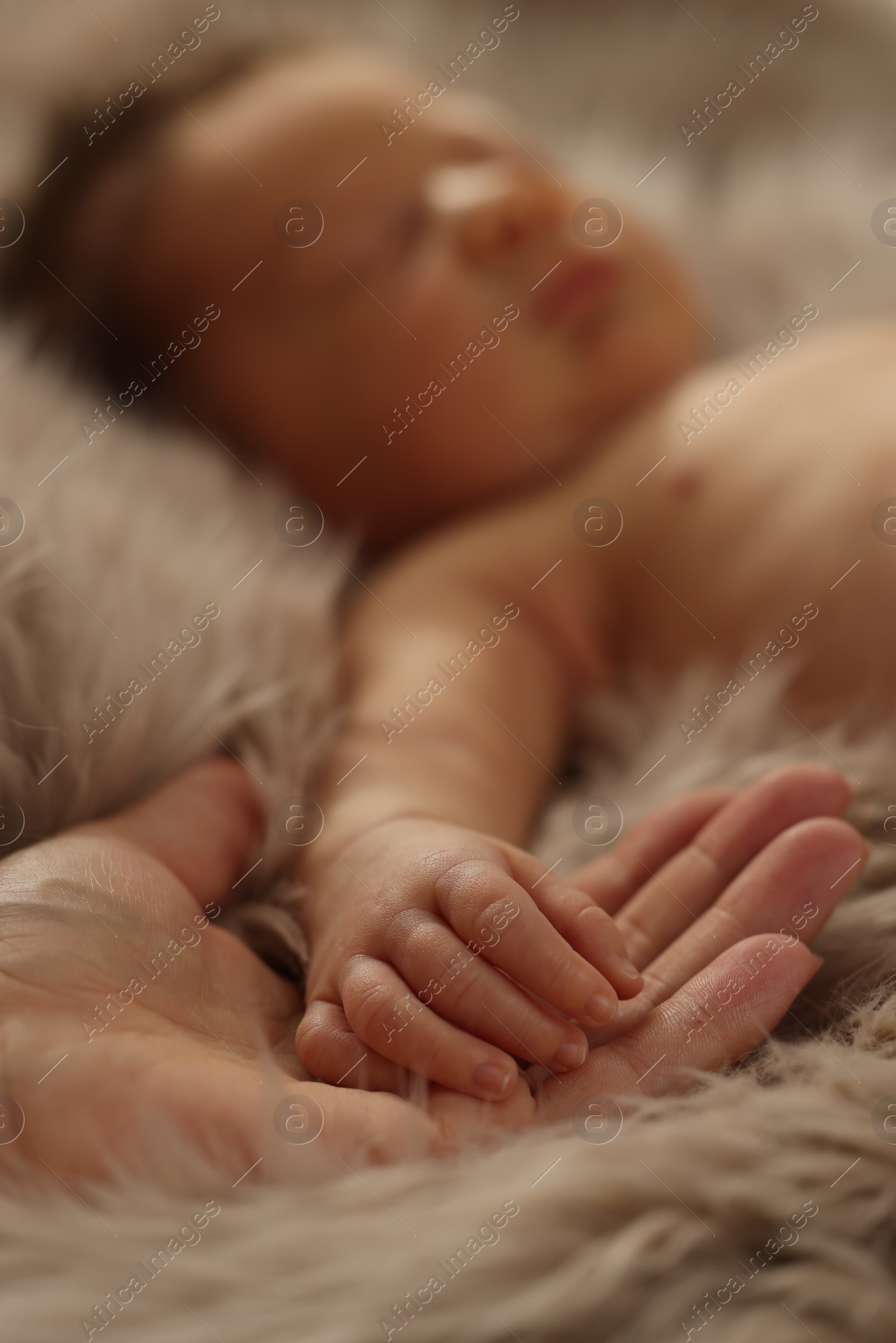 Photo of Mother with her newborn baby on fluffy blanket, closeup. Lovely family