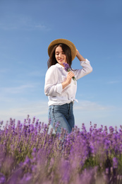 Photo of Young woman with lavender bouquet in field on summer day