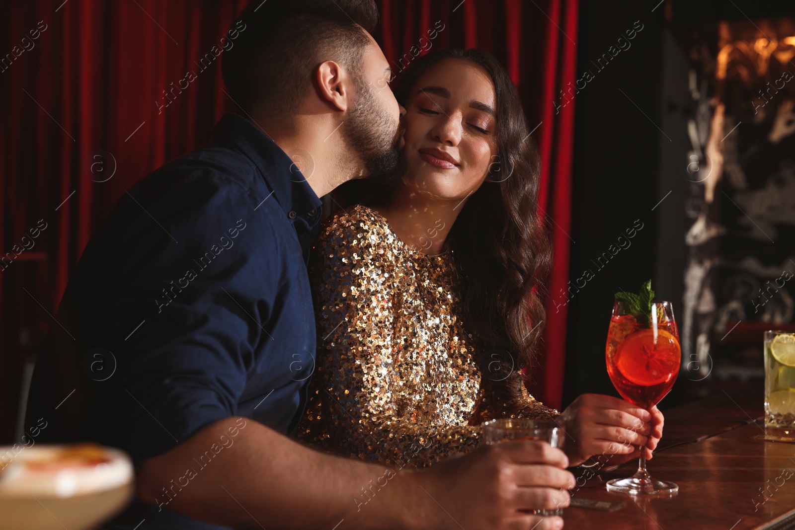 Photo of Lovely couple with fresh cocktails at bar counter