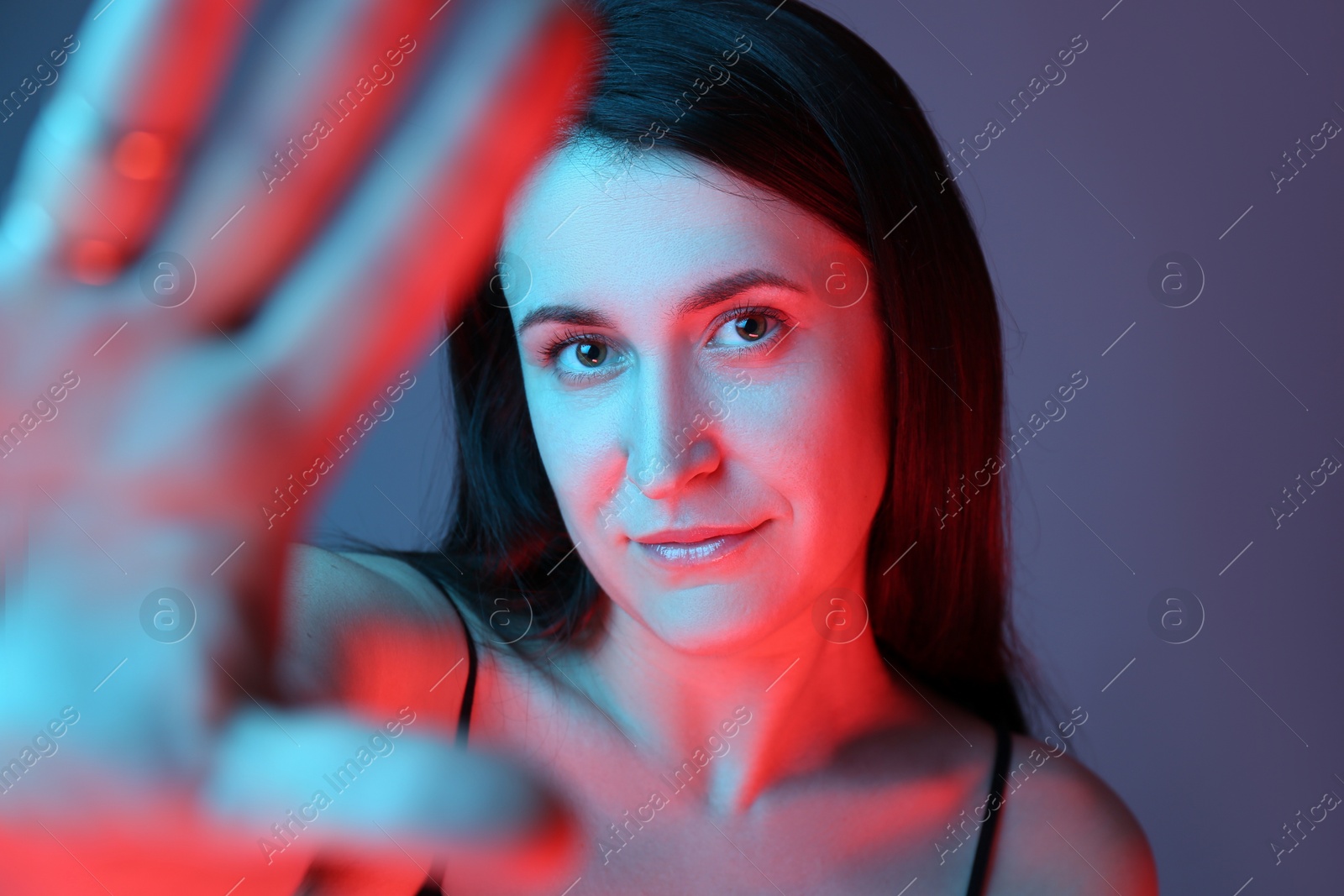 Photo of Beautiful young woman on color background, closeup