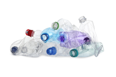 Photo of Pile of crumpled bottles isolated on white. Plastic recycling