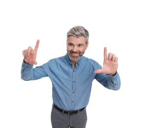 Mature businessman in stylish clothes posing on white background