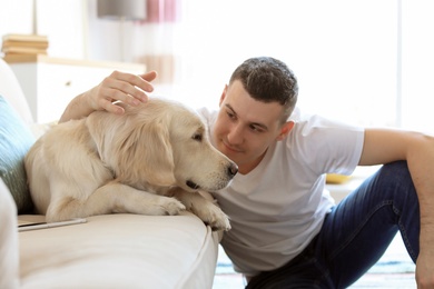 Photo of Portrait of owner with his friendly dog at home