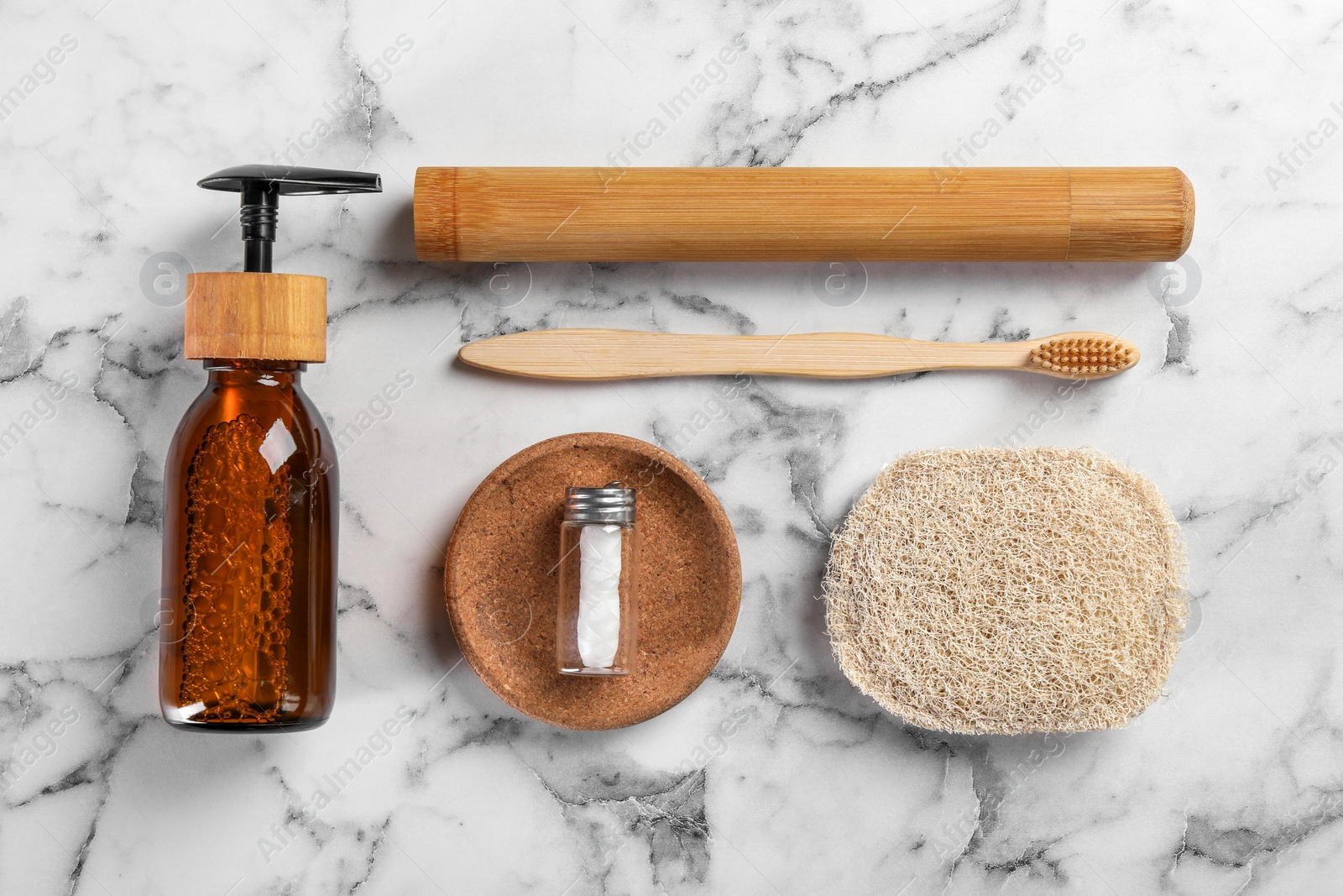 Photo of Bamboo toothbrushes and other eco friendly personal care products on white marble table, flat lay