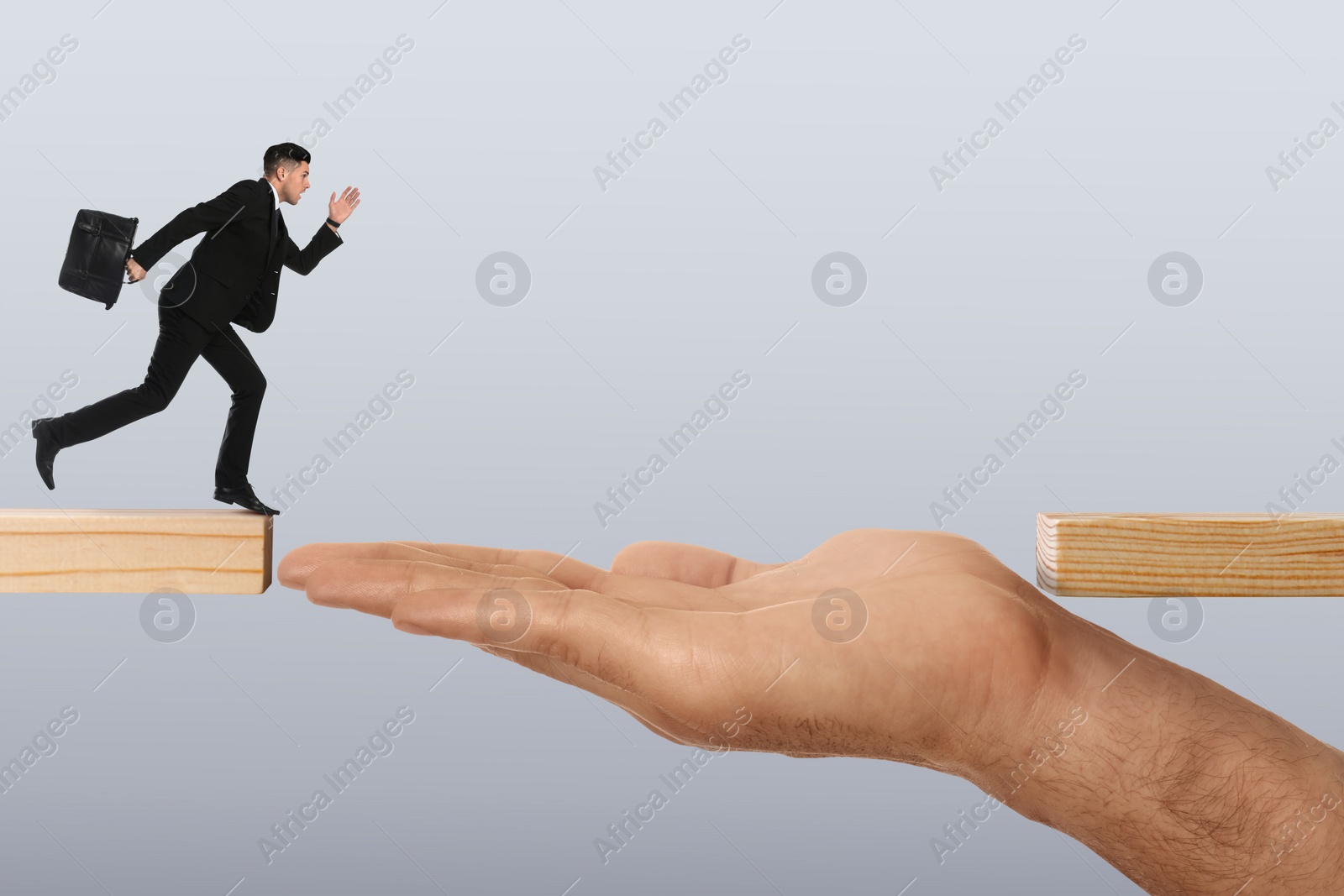 Image of Support or partnership concept. Man making bridge with his hand between wooden blocks to help running businessman